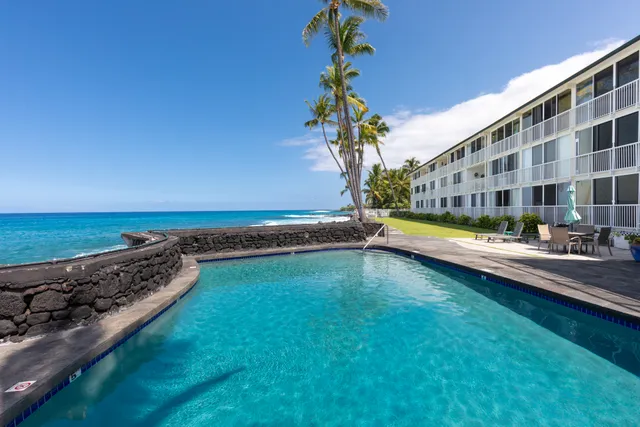 a view of a swimming pool with an outdoor seating