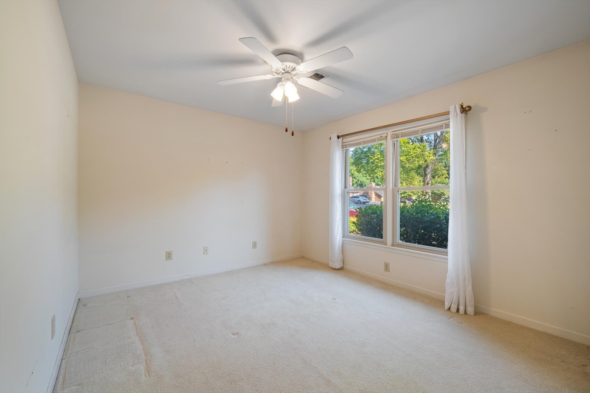768 Kent Road Nashville, TN 37214 - Photo 18 of 20 an empty room with a chandelier fan and windows
