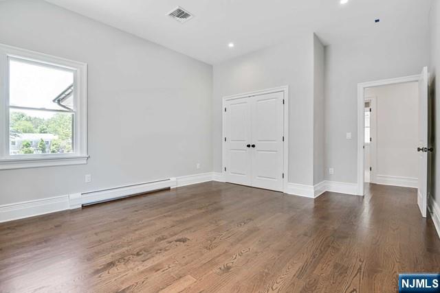 26 Bogert Street Closter, NJ 07624 - Photo 15 of 18 an empty room with wooden floor and windows
