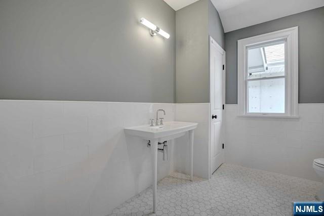 26 Bogert Street Closter, NJ 07624 - Photo 17 of 18 a bathroom with a sink and a mirror