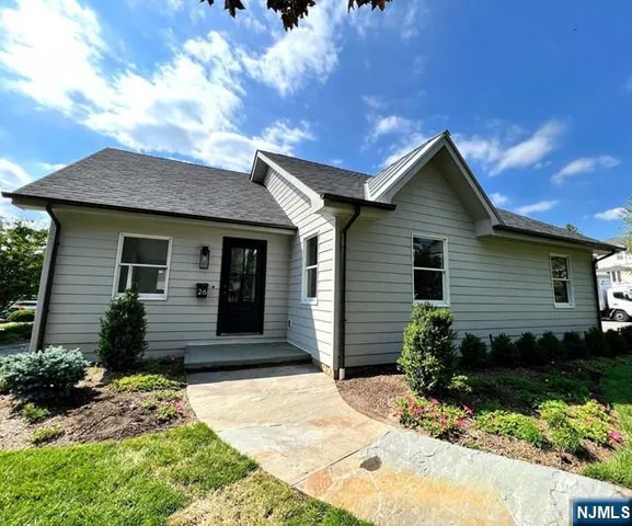 a front view of a house with a garden