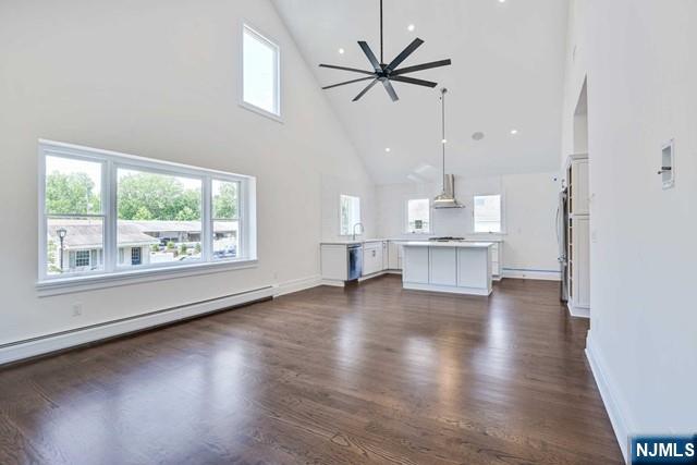 26 Bogert Street Closter, NJ 07624 - Photo 4 of 18 an empty room with wooden floor and windows