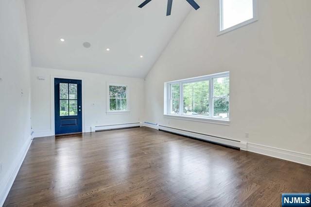 26 Bogert Street Closter, NJ 07624 - Photo 9 of 18 an empty room with wooden floor and windows