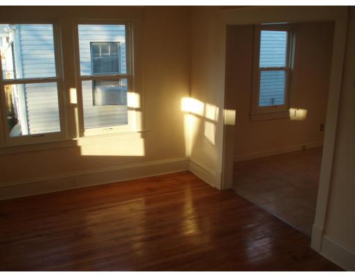 267 Abbott Street Springfield, MA 01118 - Photo 17 of 25 a view of an empty room with wooden floor and a window