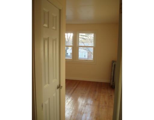 267 Abbott Street Springfield, MA 01118 - Photo 9 of 25 a view of an empty room with wooden floor and a window