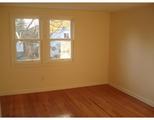 267 Abbott Street Springfield, MA 01118 - Photo 10 of 25 an empty room with wooden floor and windows