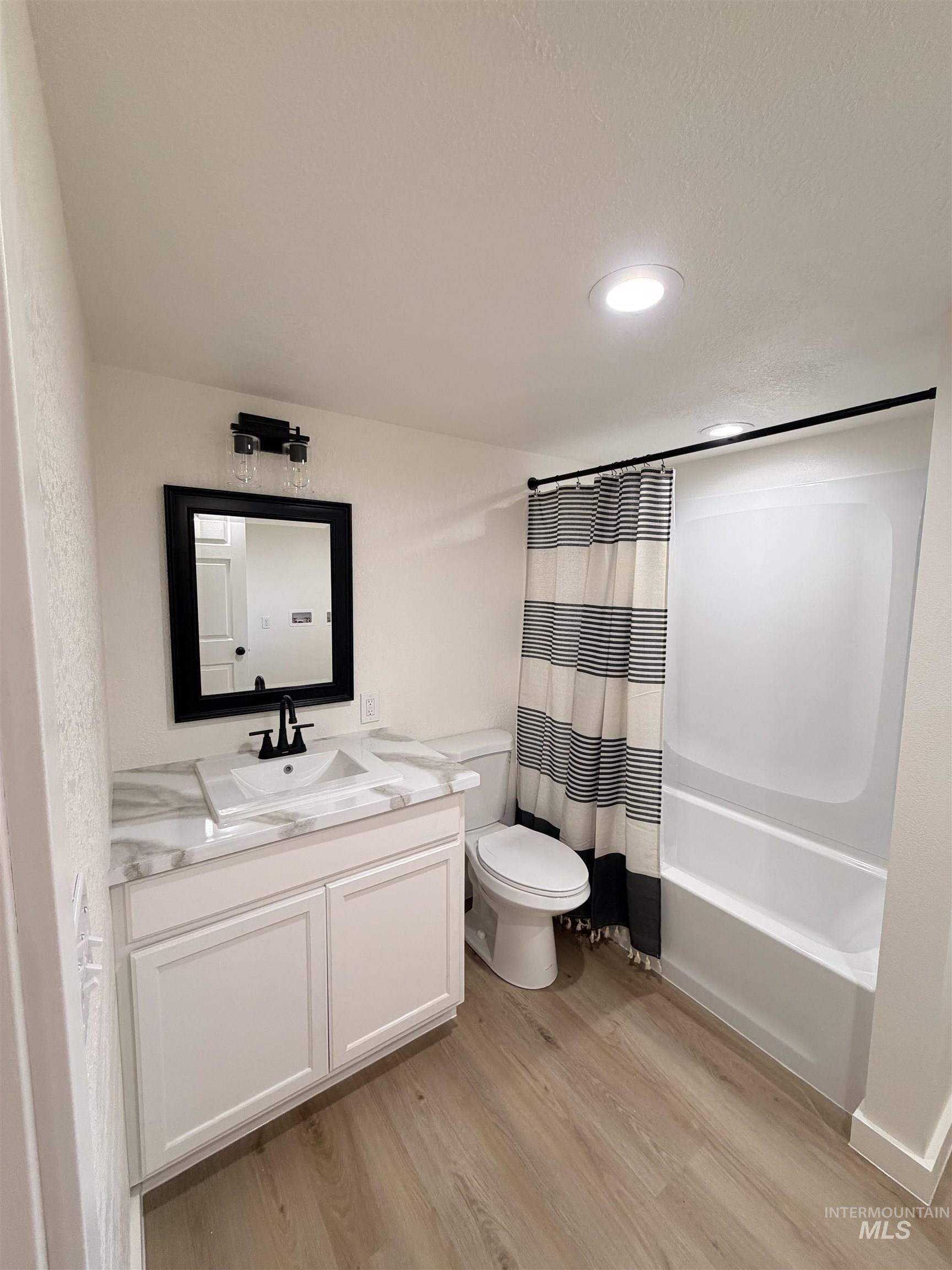 151 View Road Kamiah, ID 83536 - Photo 26 of 49 Bathroom featuring a single vanity with white cabinetry, a rectangular sink, and a marble-look countertop