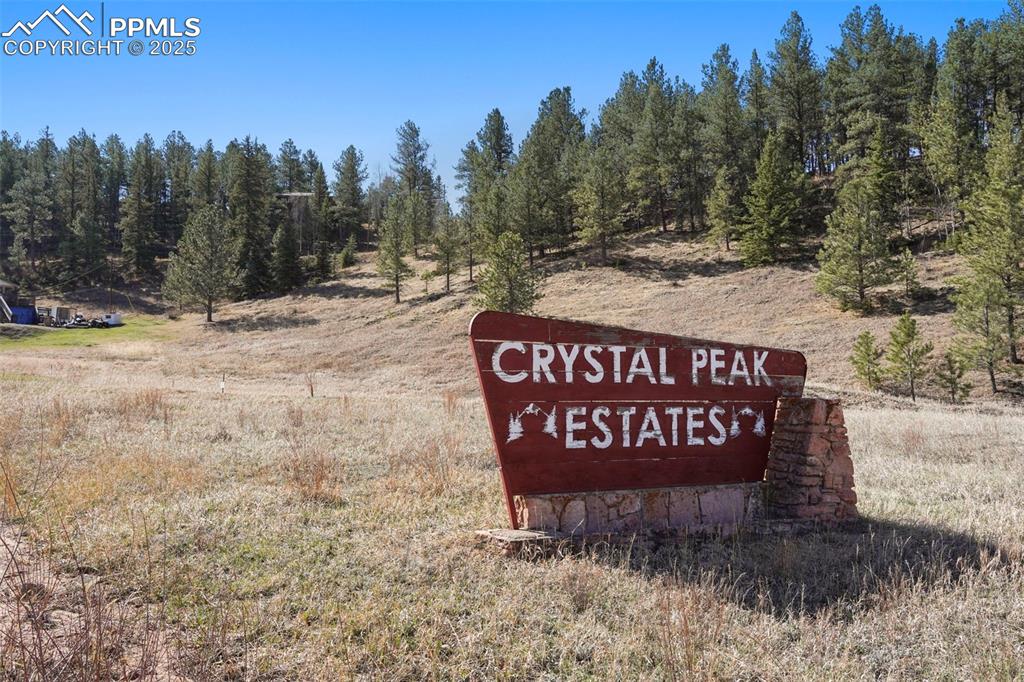 711 Crystal Peak Road Florissant, CO 80816 - Photo 8 of 12 a sign board with a bench in the background