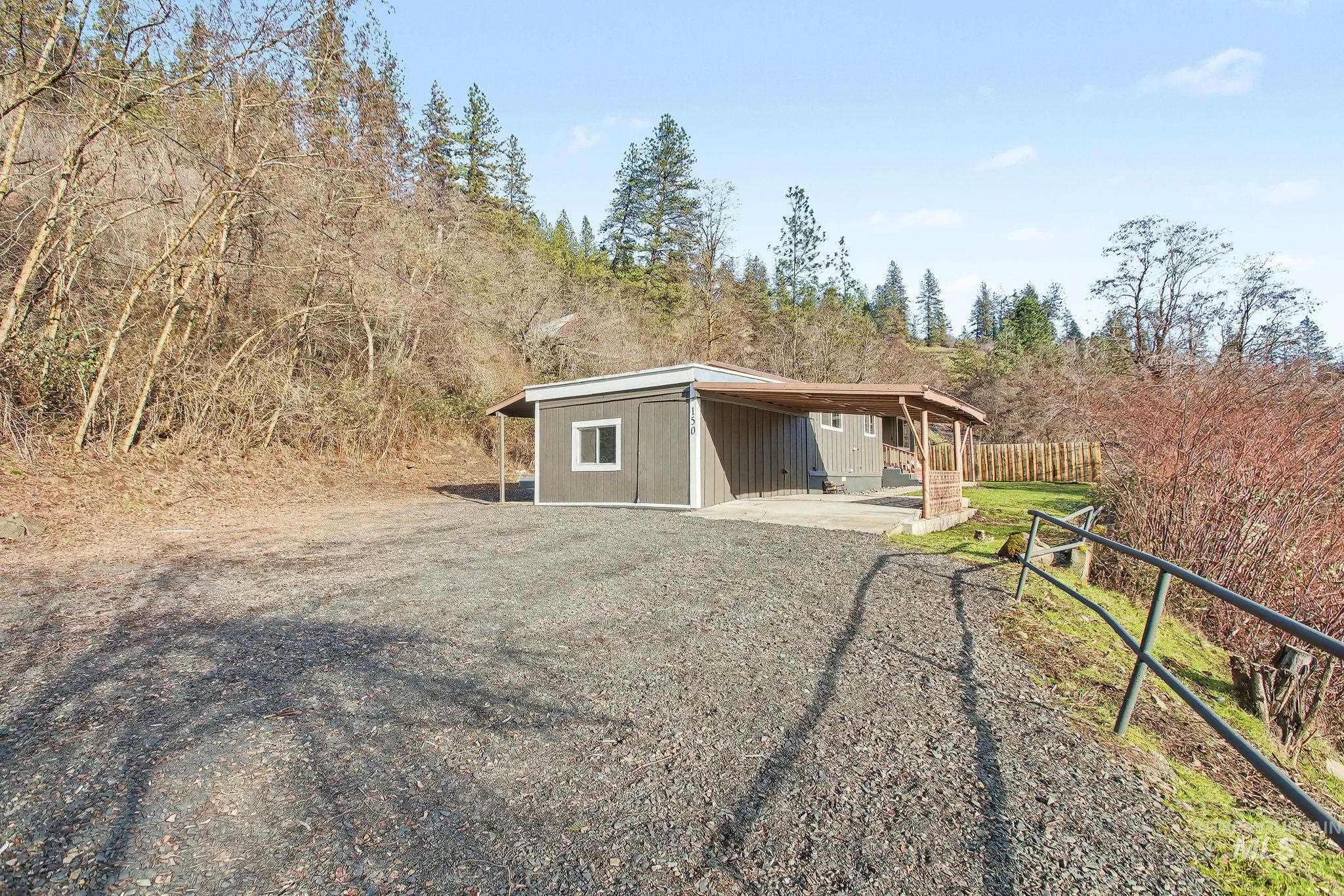 150 Elm Street Orofino, ID 83544 - Photo 34 of 36 Gray siding property with a covered patio featuring wood support posts