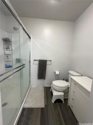 a white toilet sitting next to a bathroom sink