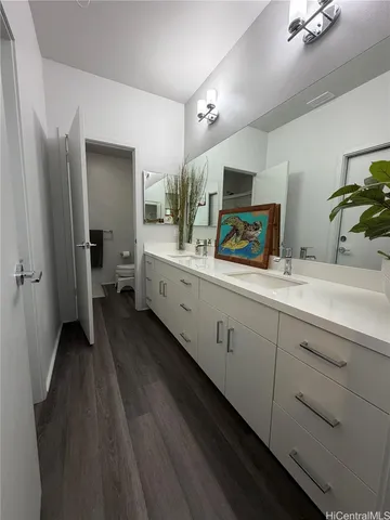a bathroom with a double vanity sink and a mirror