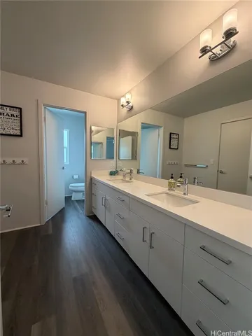 a bathroom with double vanity sinks and a mirror