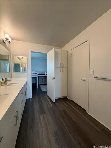 a view of a large kitchen with wooden floor and a sink