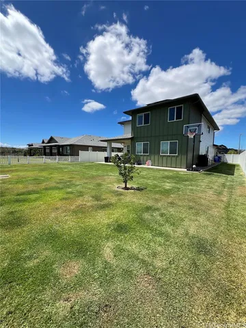 a backyard of a house with table and chairs
