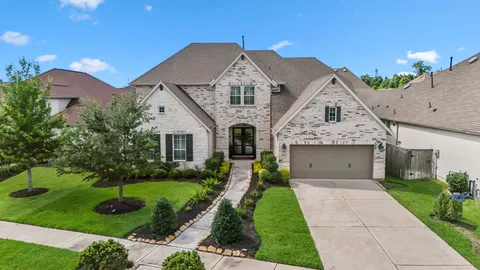 a front view of a house with a garden and plants