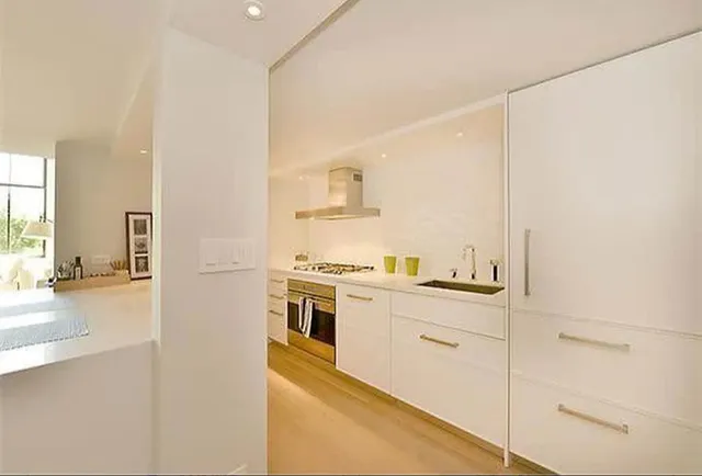 a kitchen with a stove a sink and a refrigerator