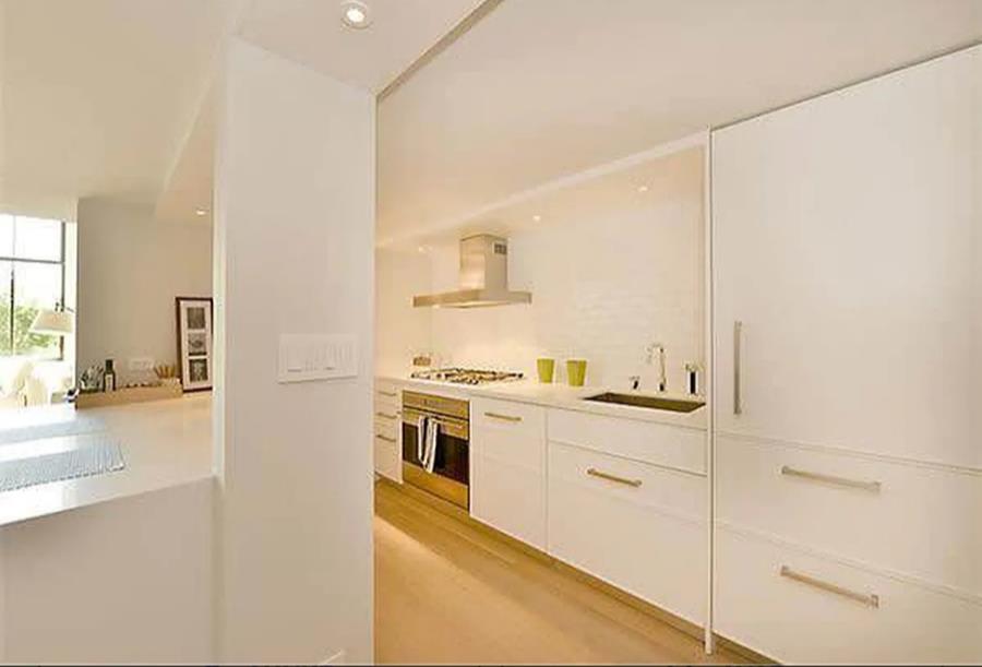421 Hudson Street, Unit 305 Manhattan, NY 10014 - Photo 4 of 13 a kitchen with a stove a sink and a refrigerator
