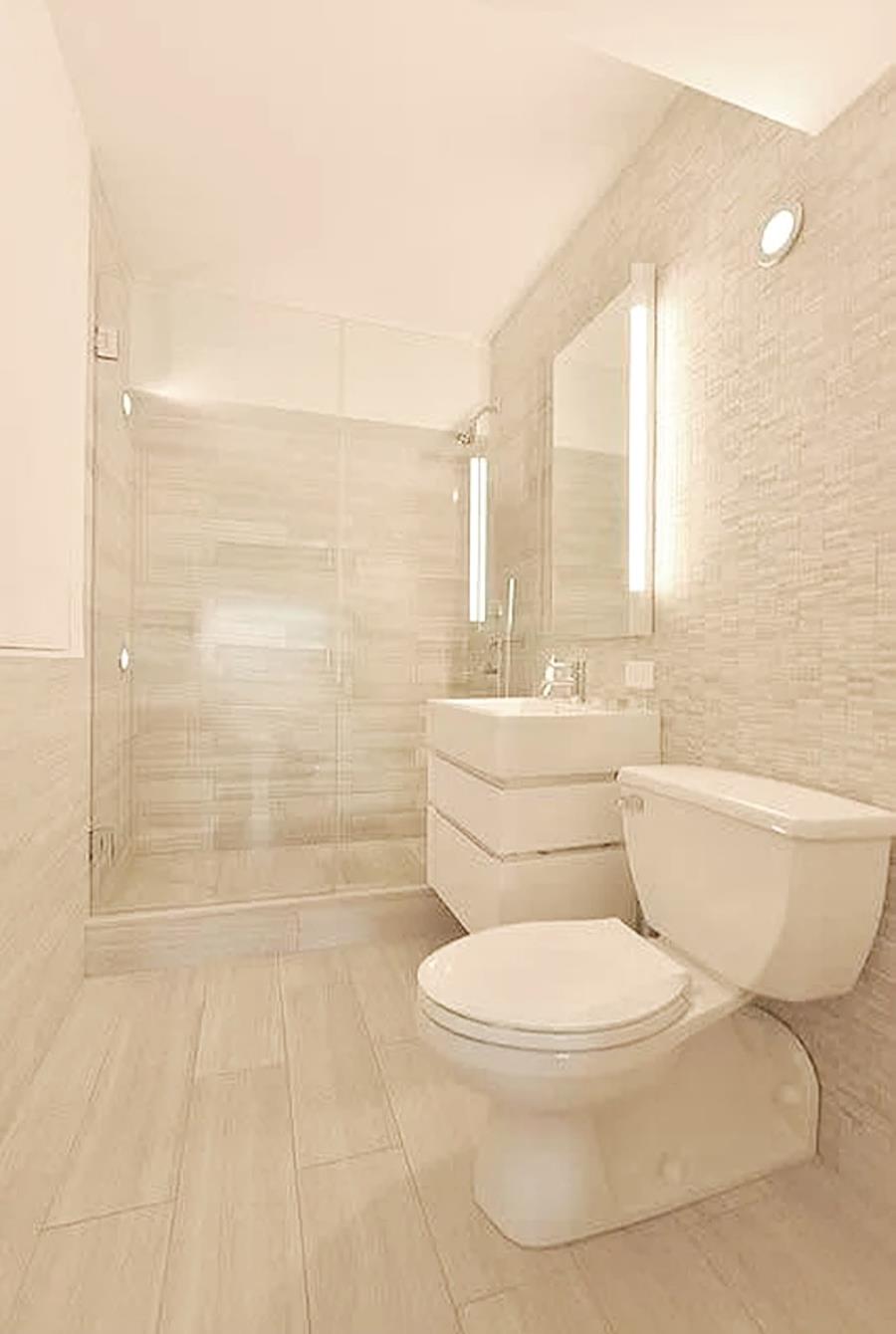 421 Hudson Street, Unit 305 Manhattan, NY 10014 - Photo 7 of 13 a white toilet sitting next to a bathroom sink