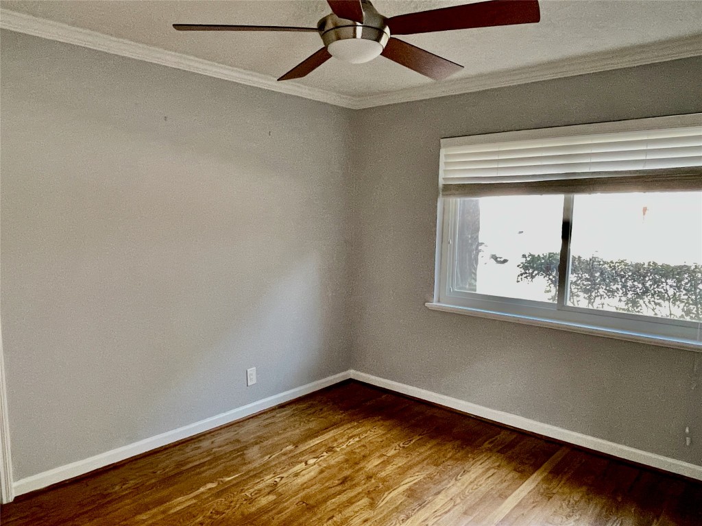 6674 Sylvan Road Houston, TX 77023 - Photo 9 of 16 a view of a room with wooden floor and a window