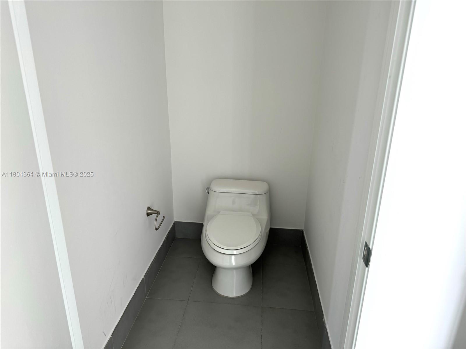 92 Southwest 3rd Street, Unit 1605 Miami, FL 33130 - Photo 11 of 21 a white toilet sitting in a bathroom