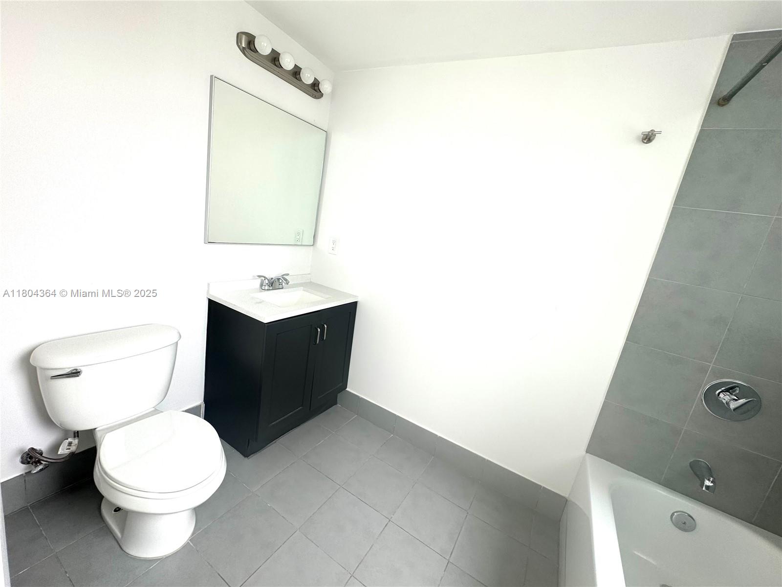 92 Southwest 3rd Street, Unit 1605 Miami, FL 33130 - Photo 18 of 21 a bathroom with a toilet sink and mirror