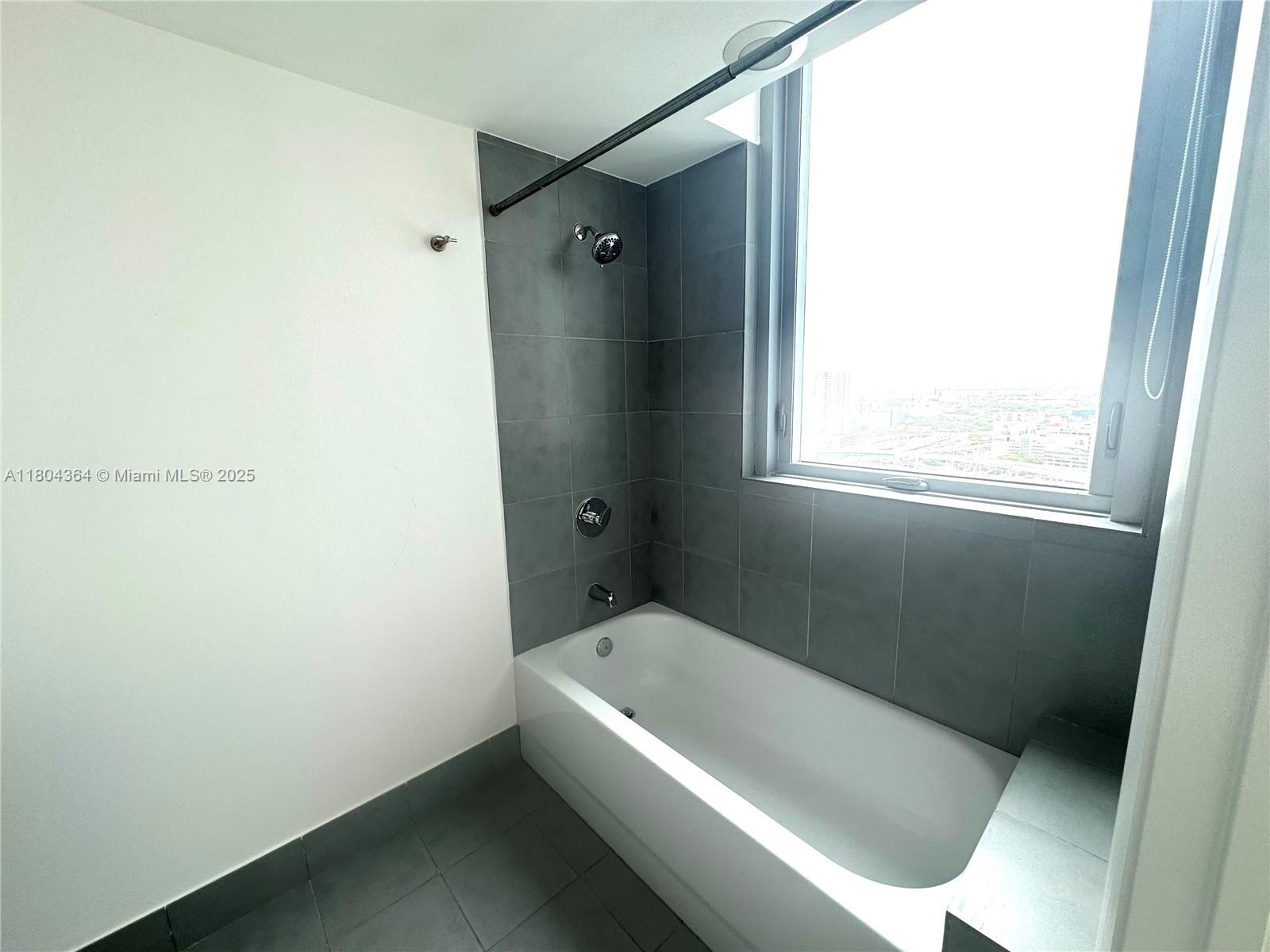 92 Southwest 3rd Street, Unit 1605 Miami, FL 33130 - Photo 19 of 21 a bathroom with a tub and shower