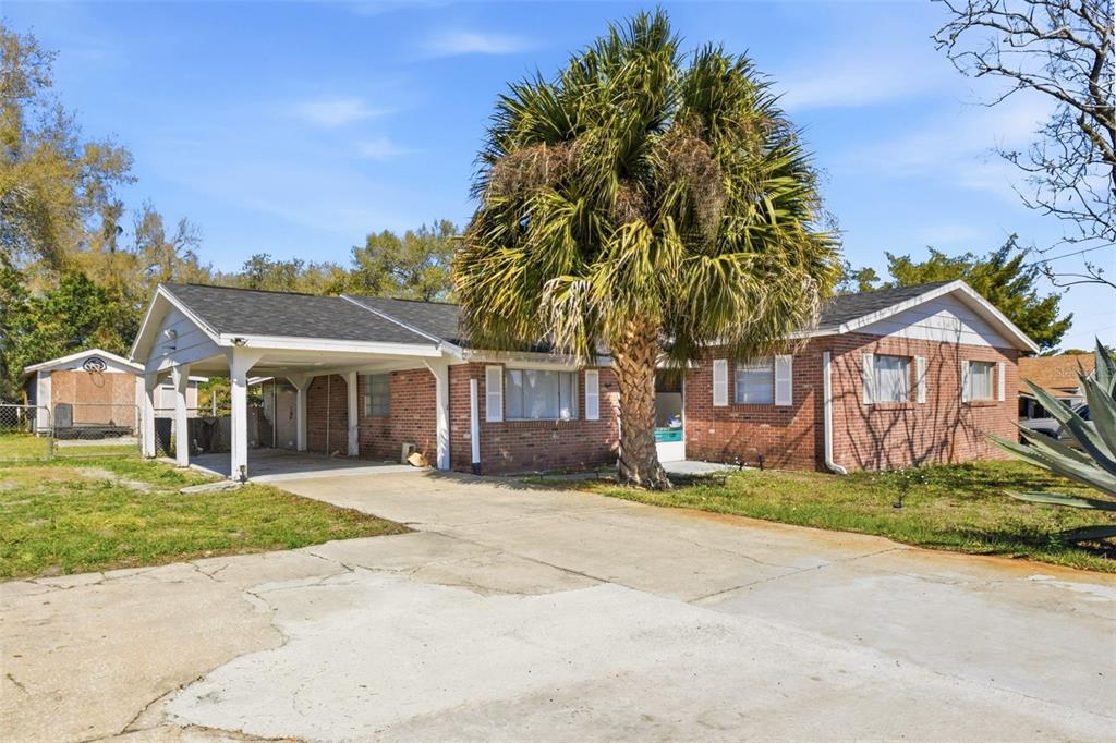 a front view of a house with a yard and trees