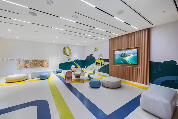 a media room with lots of chairs and a projector screen