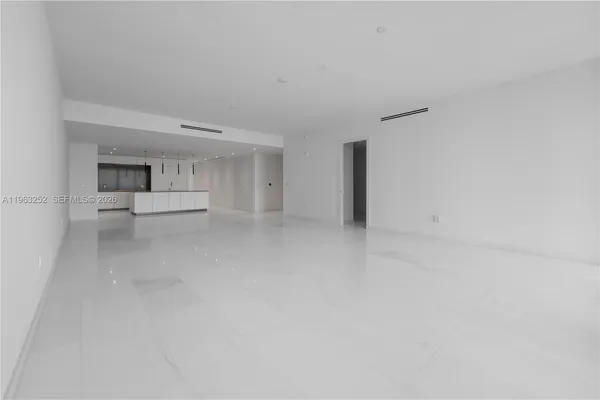 a living room with stainless steel appliances kitchen island granite countertop furniture and a large window