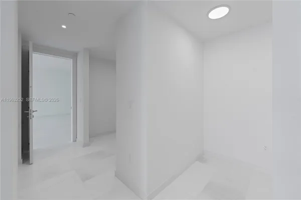 an empty room with sliding glass door