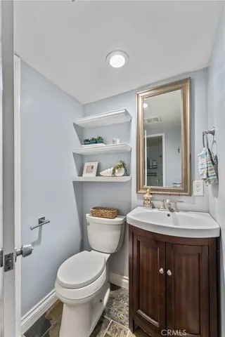 a bathroom with a sink a toilet and a mirror