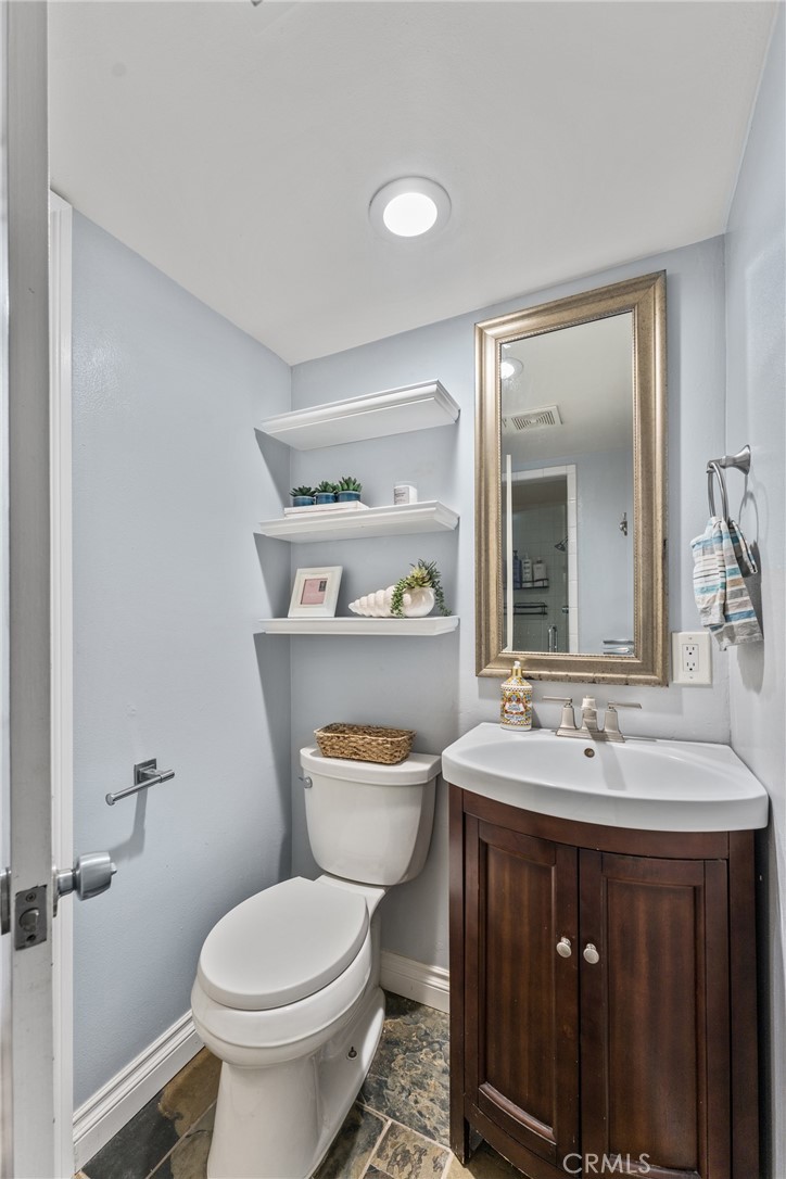 1550 West Palais Road Anaheim, CA 92802 - Photo 11 of 15 a bathroom with a sink a toilet and a mirror