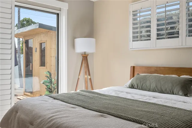 a bedroom with a bed and a painting on the wall