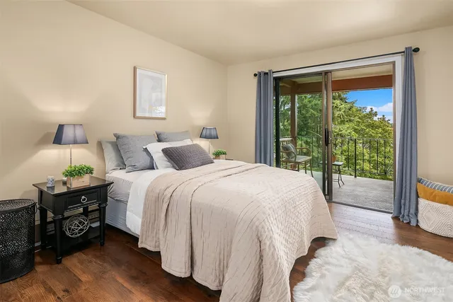 a spacious bedroom with a bed and a large window