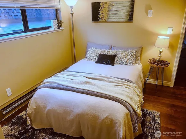 a bed sitting in a bedroom next to a window