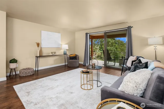 a living room with furniture windows and a table