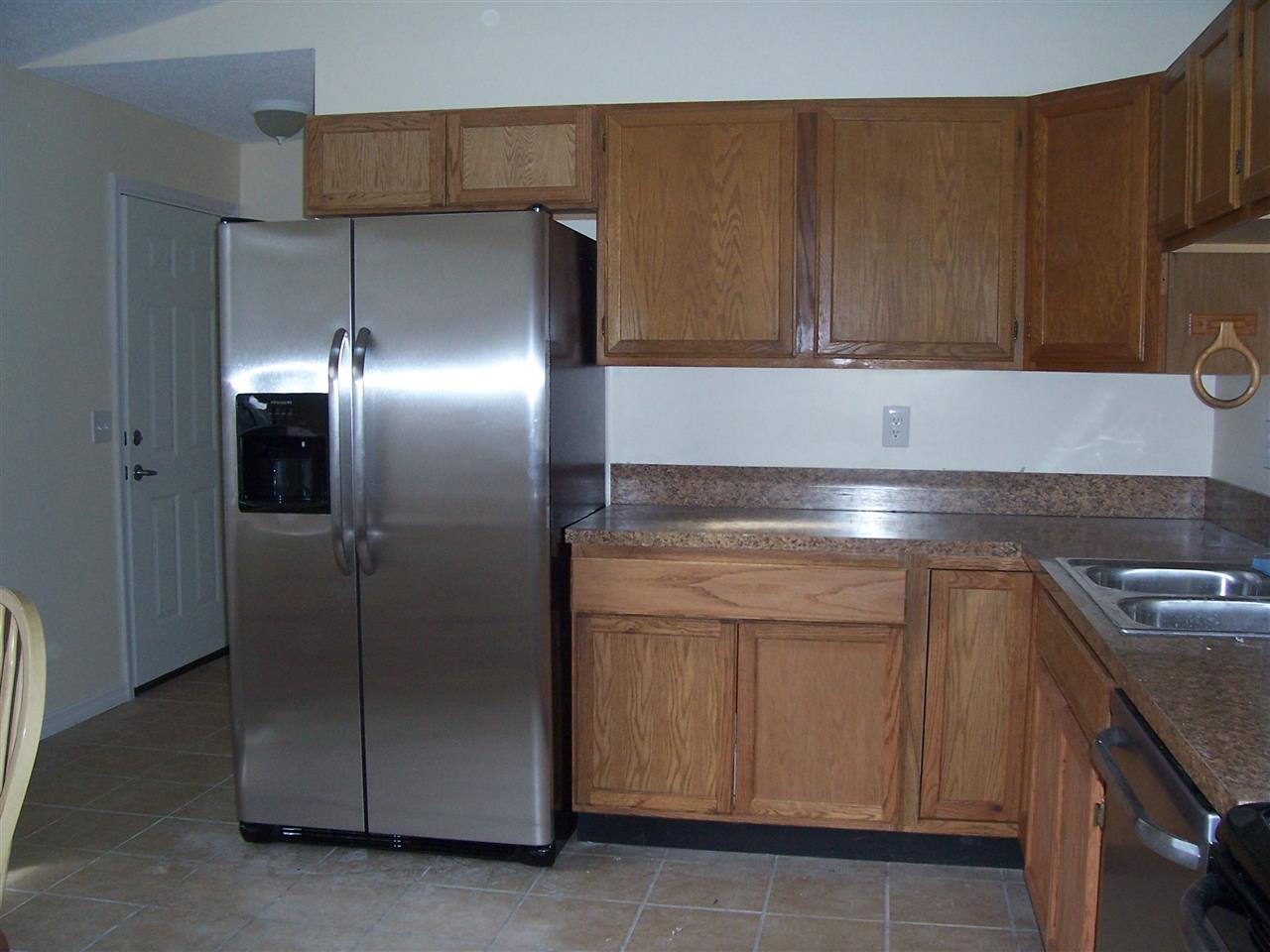 145 Cornell Road St. Augustine, FL 32086 - Photo 2 of 10 a kitchen with cabinets and stainless steel appliances