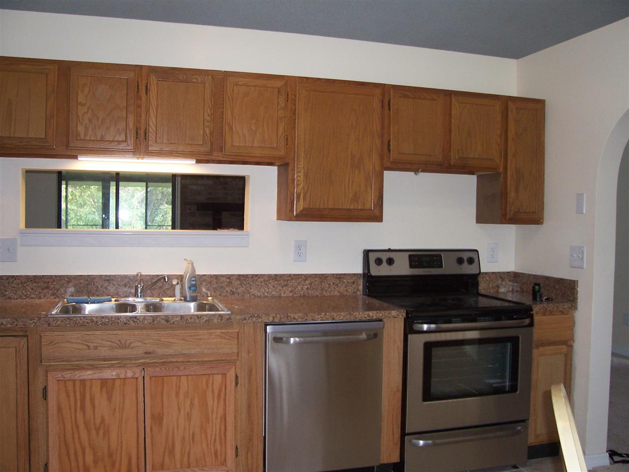 145 Cornell Road St. Augustine, FL 32086 - Photo 3 of 10 a kitchen with granite countertop a stove top oven microwave and cabinets