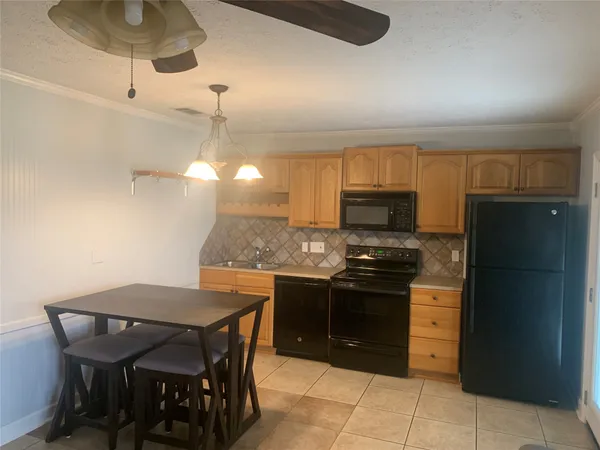 a kitchen with stainless steel appliances granite countertop a stove and a refrigerator