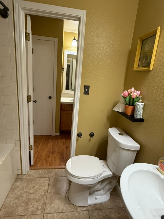 1707 Morningside Cove Round Rock, TX 78664 - Photo 14 of 31 a white toilet sitting next to a bathroom sink