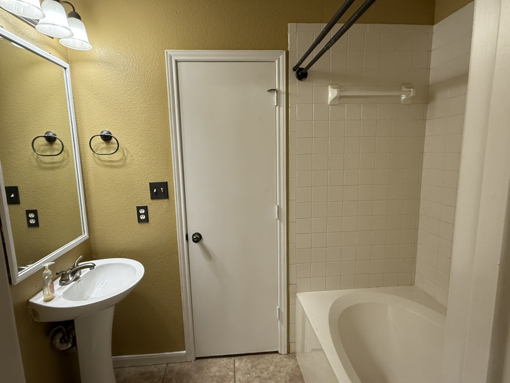 1707 Morningside Cove Round Rock, TX 78664 - Photo 16 of 31 a bathroom with a sink a mirror a bathtub and shower