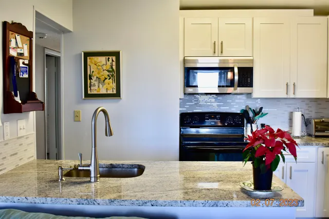 a kitchen with a sink and a stove top oven