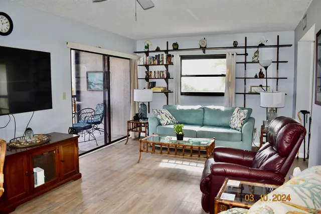 a living room with furniture fireplace and a large window