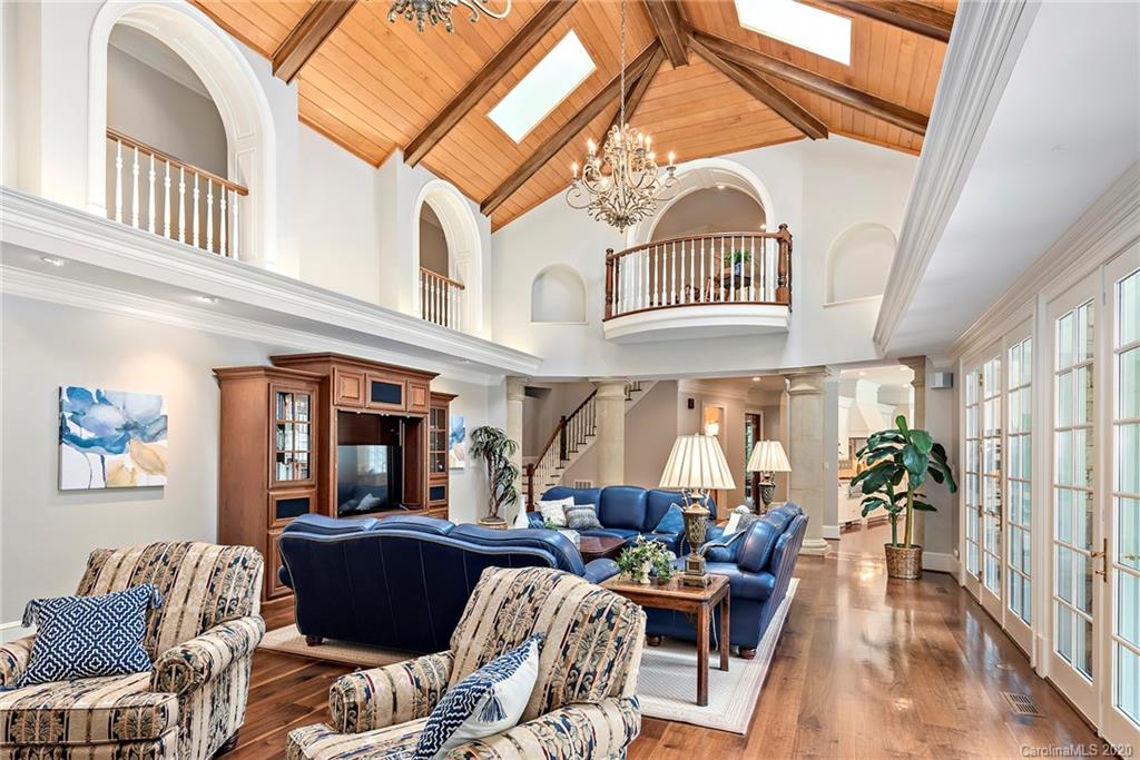 8333 Providence Road Charlotte, NC 28277 - Photo 23 of 47 a living room with furniture a fireplace and lots of windows