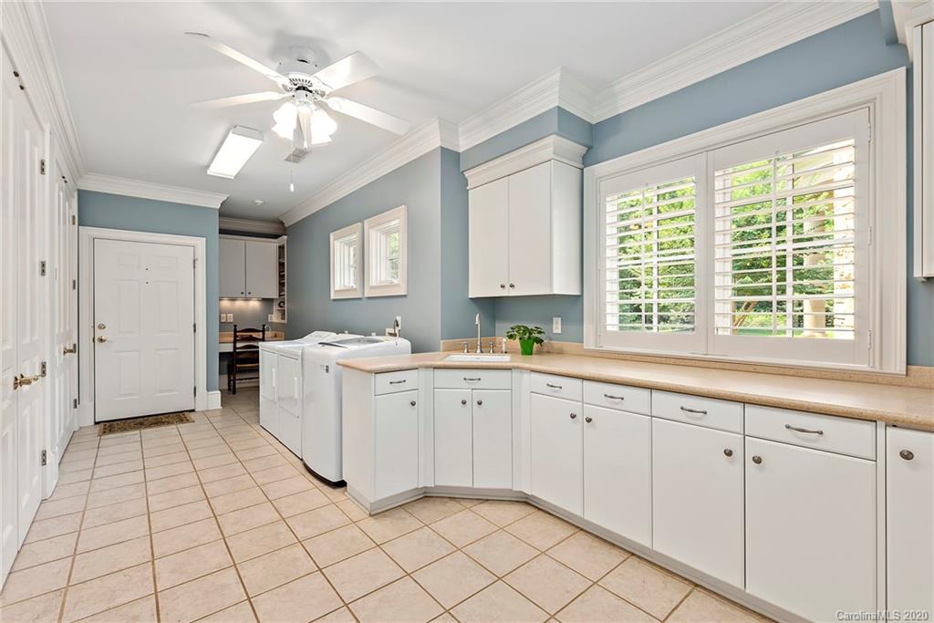 8333 Providence Road Charlotte, NC 28277 - Photo 27 of 47 a large white kitchen with a window and cabinets