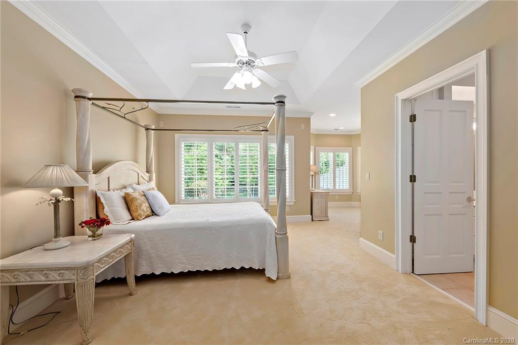 8333 Providence Road Charlotte, NC 28277 - Photo 29 of 47 a bedroom with a bed and a chandelier