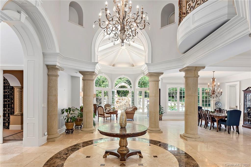 8333 Providence Road Charlotte, NC 28277 - Photo 4 of 47 a view of a dining room with furniture wooden floor and chandelier
