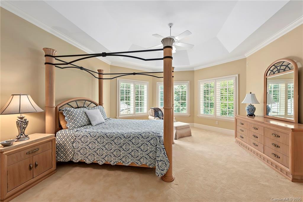 8333 Providence Road Charlotte, NC 28277 - Photo 31 of 47 a bedroom with a bed a chandelier and a window