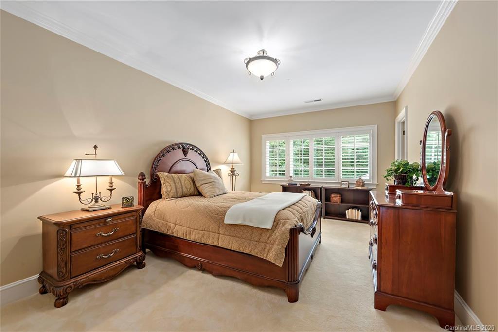 8333 Providence Road Charlotte, NC 28277 - Photo 32 of 47 a spacious bedroom with a bed and a large window