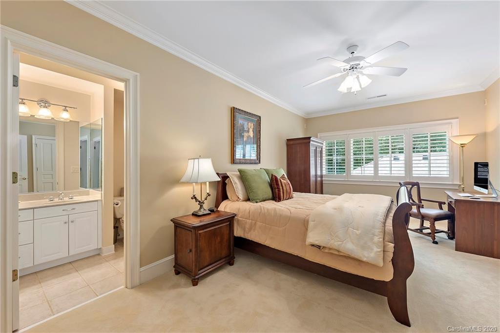 8333 Providence Road Charlotte, NC 28277 - Photo 34 of 47 a bedroom with a bed and a chandelier